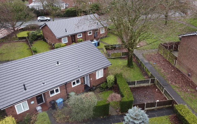 Aerial view of a row of bungalows with new grey roofs